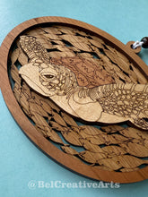Load image into Gallery viewer, Green sea turtle wooden layered ornament, handcrafted with mahogany, maple, and sapele veneers, 5.5" wide by 4.4" tall, made in Virginia, USA, @BelCreativeArts
