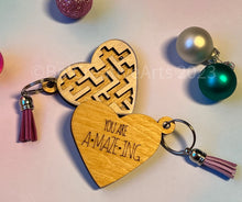 Load image into Gallery viewer, Valentine's Day gift, heart-shaped wooden maze puzzle with metal bead and clear acrylic top, with attached metal ring and colorful tassel by @belcreativearts